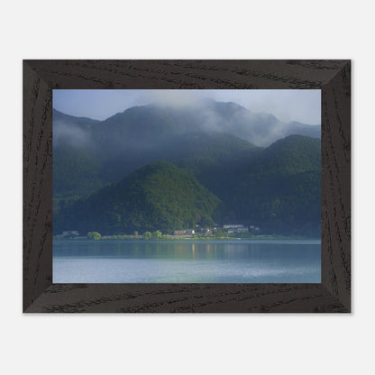 This misty lake mountain landscape wall art print captures serene blue tones and tranquil natural scenery, making it ideal for minimalist home decor. Designed for calming interiors, this fine art nature photography print enhances spaces with peaceful lake reflections, foggy mountain layers, and soft atmospheric light. A perfect choice for those seeking calming wall art, nature-inspired decor, or serene landscape prints for modern homes.