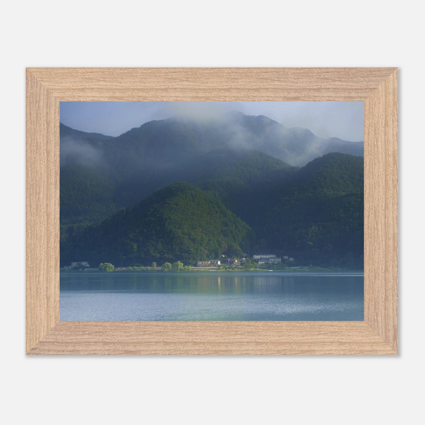 This misty lake mountain landscape wall art print captures serene blue tones and tranquil natural scenery, making it ideal for minimalist home decor. Designed for calming interiors, this fine art nature photography print enhances spaces with peaceful lake reflections, foggy mountain layers, and soft atmospheric light. A perfect choice for those seeking calming wall art, nature-inspired decor, or serene landscape prints for modern homes.