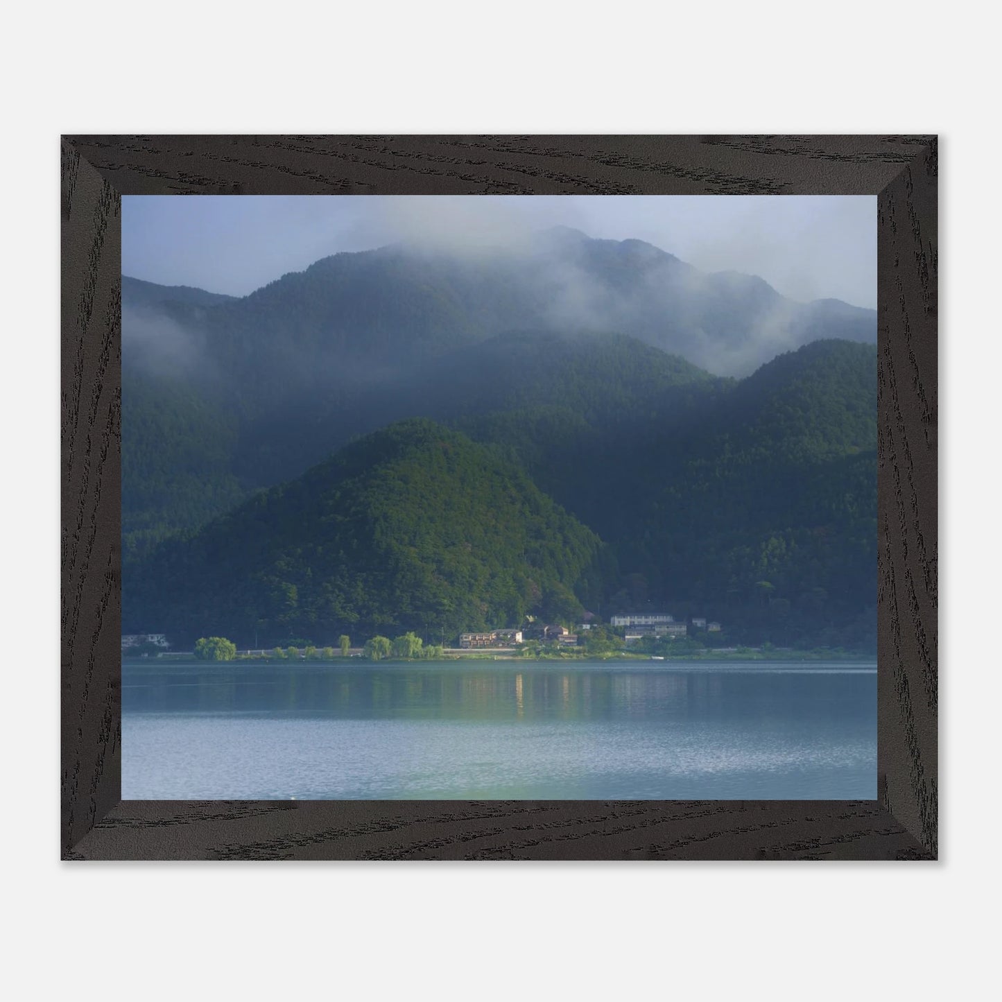 This misty lake mountain landscape wall art print captures serene blue tones and tranquil natural scenery, making it ideal for minimalist home decor. Designed for calming interiors, this fine art nature photography print enhances spaces with peaceful lake reflections, foggy mountain layers, and soft atmospheric light. A perfect choice for those seeking calming wall art, nature-inspired decor, or serene landscape prints for modern homes.