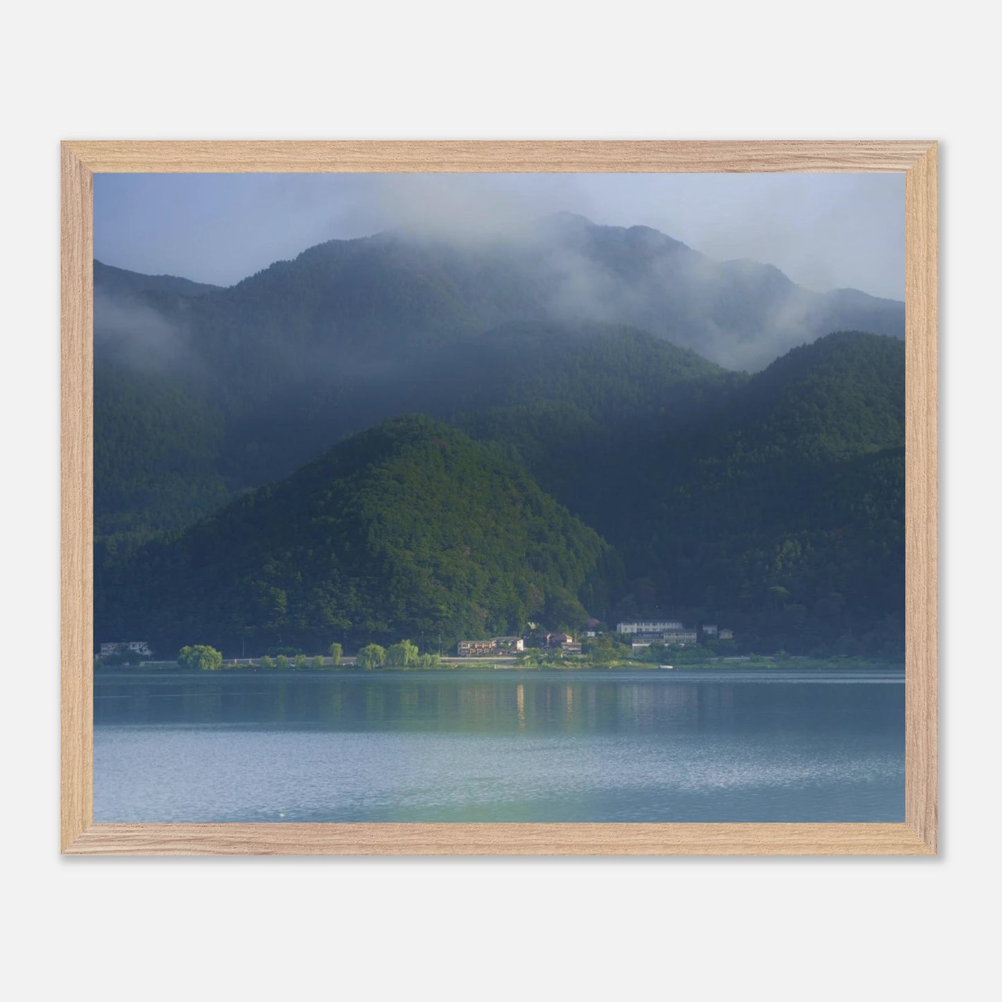 This misty lake mountain landscape wall art print captures serene blue tones and tranquil natural scenery, making it ideal for minimalist home decor. Designed for calming interiors, this fine art nature photography print enhances spaces with peaceful lake reflections, foggy mountain layers, and soft atmospheric light. A perfect choice for those seeking calming wall art, nature-inspired decor, or serene landscape prints for modern homes.
