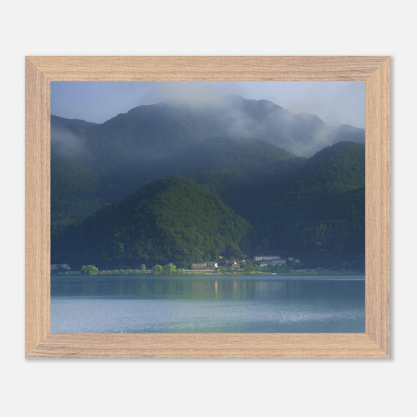 This misty lake mountain landscape wall art print captures serene blue tones and tranquil natural scenery, making it ideal for minimalist home decor. Designed for calming interiors, this fine art nature photography print enhances spaces with peaceful lake reflections, foggy mountain layers, and soft atmospheric light. A perfect choice for those seeking calming wall art, nature-inspired decor, or serene landscape prints for modern homes.