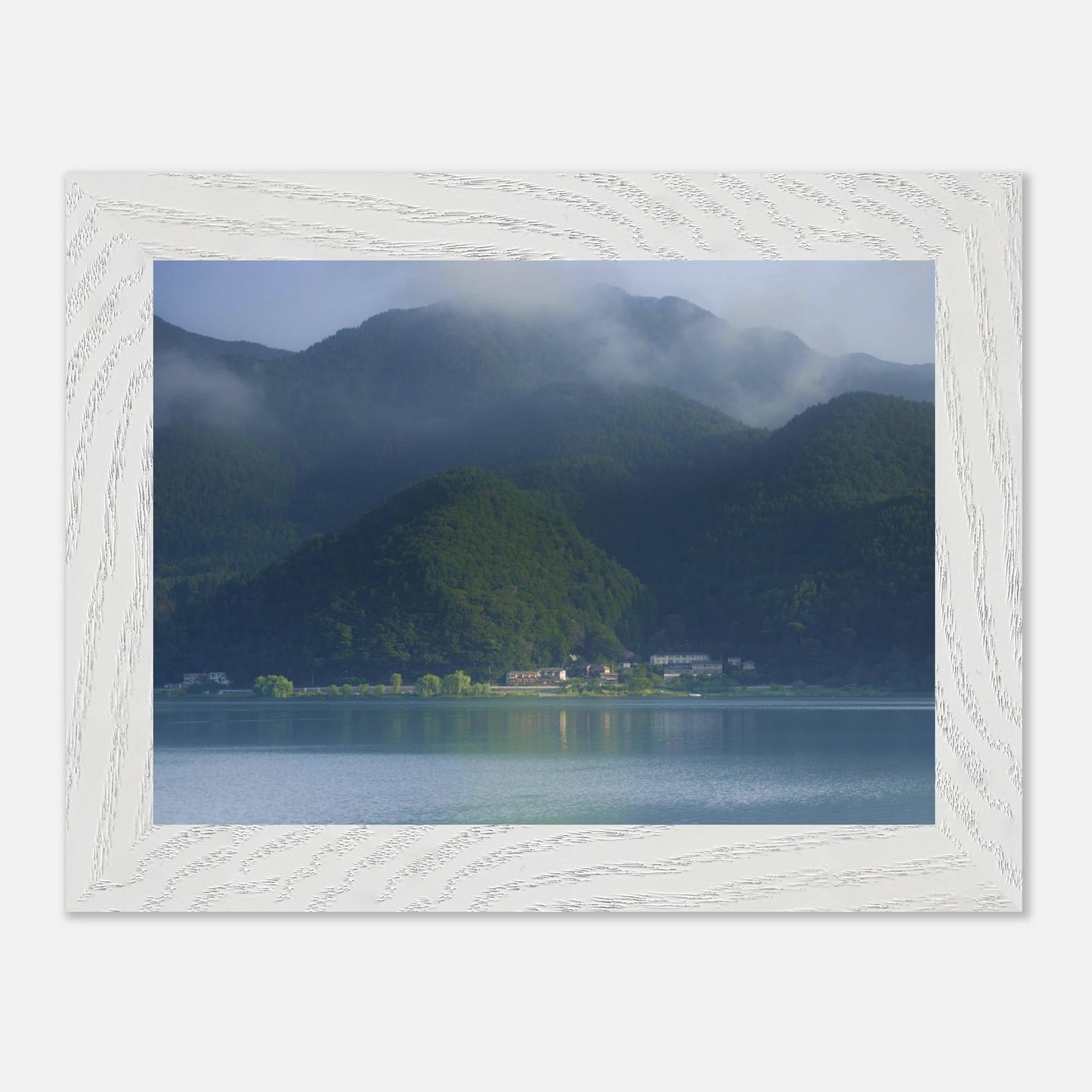 This misty lake mountain landscape wall art print captures serene blue tones and tranquil natural scenery, making it ideal for minimalist home decor. Designed for calming interiors, this fine art nature photography print enhances spaces with peaceful lake reflections, foggy mountain layers, and soft atmospheric light. A perfect choice for those seeking calming wall art, nature-inspired decor, or serene landscape prints for modern homes.