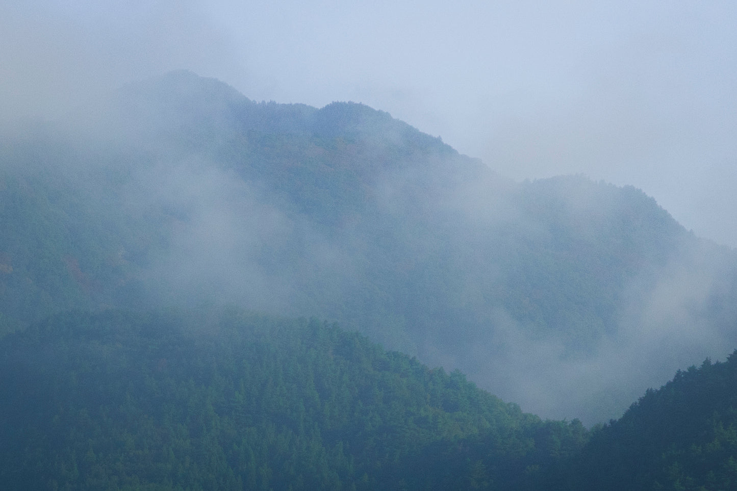 This misty lake mountain landscape wall art print captures serene blue tones and tranquil natural scenery, making it ideal for minimalist home decor. Designed for calming interiors, this fine art nature photography print enhances spaces with peaceful lake reflections, foggy mountain layers, and soft atmospheric light. A perfect choice for those seeking calming wall art, nature-inspired decor, or serene landscape prints for modern homes.