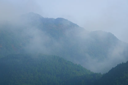 This misty lake mountain landscape wall art print captures serene blue tones and tranquil natural scenery, making it ideal for minimalist home decor. Designed for calming interiors, this fine art nature photography print enhances spaces with peaceful lake reflections, foggy mountain layers, and soft atmospheric light. A perfect choice for those seeking calming wall art, nature-inspired decor, or serene landscape prints for modern homes.