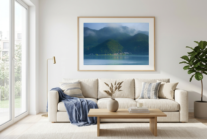 This misty lake mountain landscape wall art print captures serene blue tones and tranquil natural scenery, making it ideal for minimalist home decor. Designed for calming interiors, this fine art nature photography print enhances spaces with peaceful lake reflections, foggy mountain layers, and soft atmospheric light. A perfect choice for those seeking calming wall art, nature-inspired decor, or serene landscape prints for modern homes.