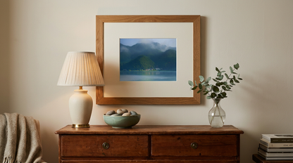 This misty lake mountain landscape wall art print captures serene blue tones and tranquil natural scenery, making it ideal for minimalist home decor. Designed for calming interiors, this fine art nature photography print enhances spaces with peaceful lake reflections, foggy mountain layers, and soft atmospheric light. A perfect choice for those seeking calming wall art, nature-inspired decor, or serene landscape prints for modern homes.