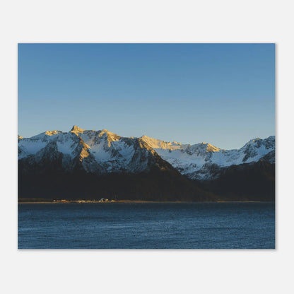 This calming mountain and ocean wall art print features a minimalist landscape with blue tones and soft natural light. 