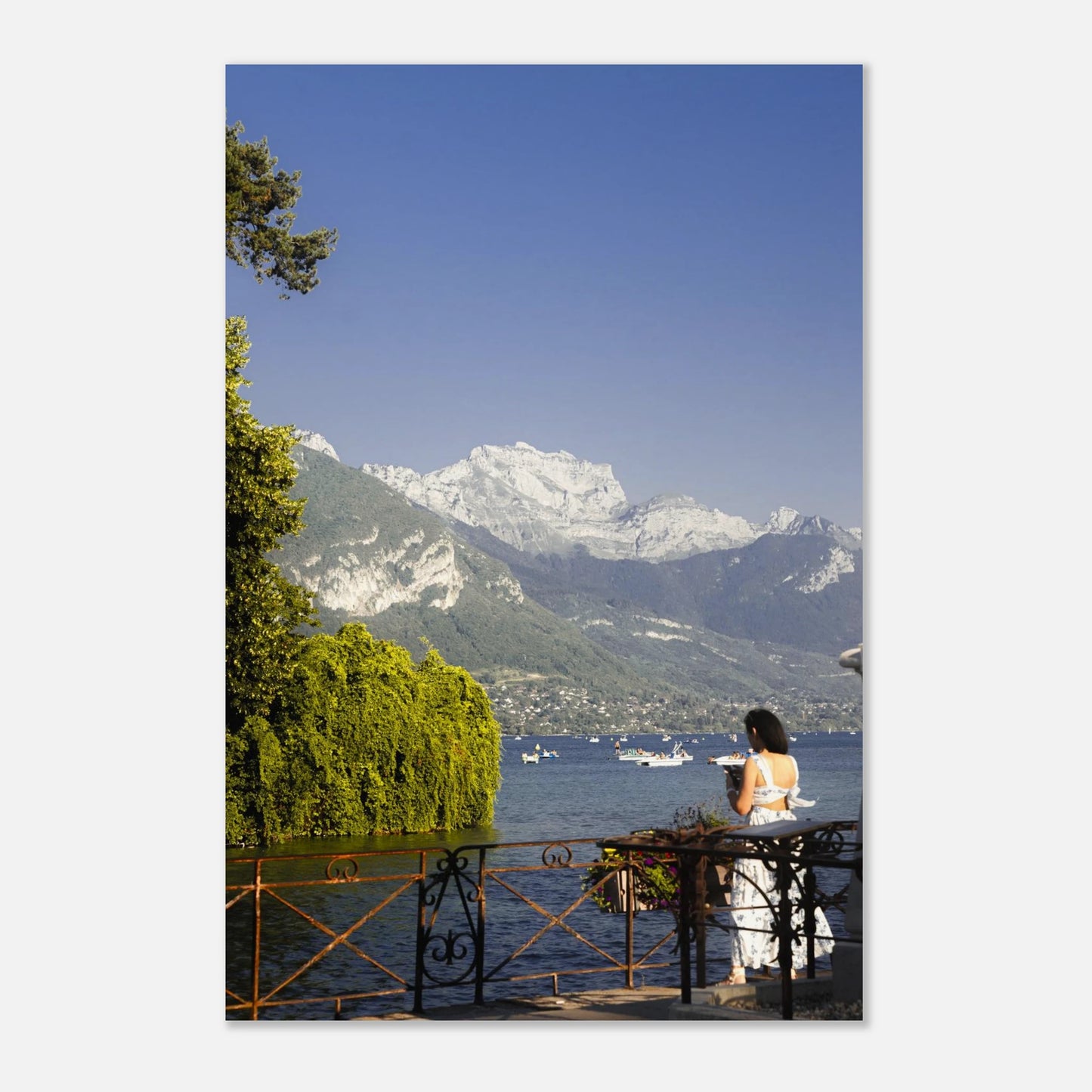 This alpine lake wall art print features serene blue tones, mountain landscapes, and a peaceful waterside setting, making it ideal for minimalist and modern interiors. Inspired by European lakeside scenery, this fine art photography print brings calm, light, and openness into your home. Perfect for those seeking tranquil wall art, mountain lake decor, or serene nature photography for living rooms and bedrooms