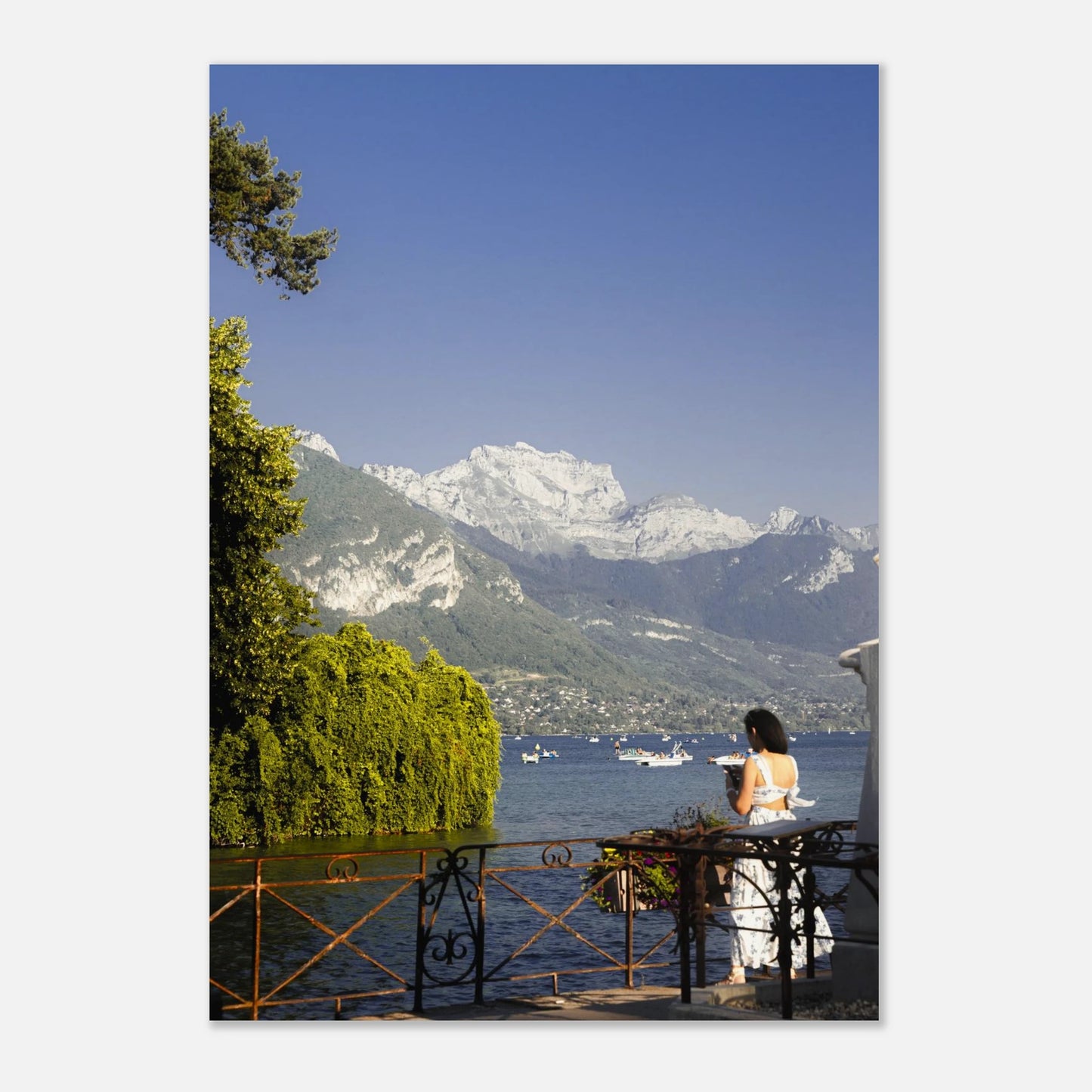 This alpine lake wall art print features serene blue tones, mountain landscapes, and a peaceful waterside setting, making it ideal for minimalist and modern interiors. Inspired by European lakeside scenery, this fine art photography print brings calm, light, and openness into your home. Perfect for those seeking tranquil wall art, mountain lake decor, or serene nature photography for living rooms and bedrooms