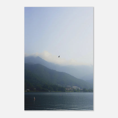 This minimalist mountain lake photography print features a serene blue-toned landscape with a bird in flight, making it ideal for calm wall art, Japandi decor, and modern minimalist interiors. Perfect for living rooms, bedrooms, and offices, this fine art print enhances spaces with soft blue hues, atmospheric depth, and a peaceful, elevated aesthetic.