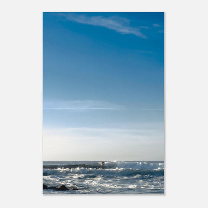 This minimalist ocean photography print features a serene blue seascape with a distant surfer, making it ideal for coastal wall art, calm interior design, and modern minimalist decor. Designed for those seeking premium fine art prints with soft blue tones, it enhances living rooms, bedrooms, and office spaces with a sense of tranquility and refined simplicity.