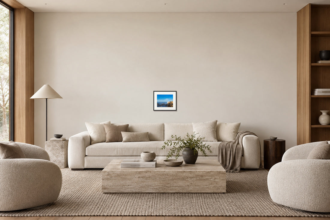 Medium framed coastal artwork above the same sofa
