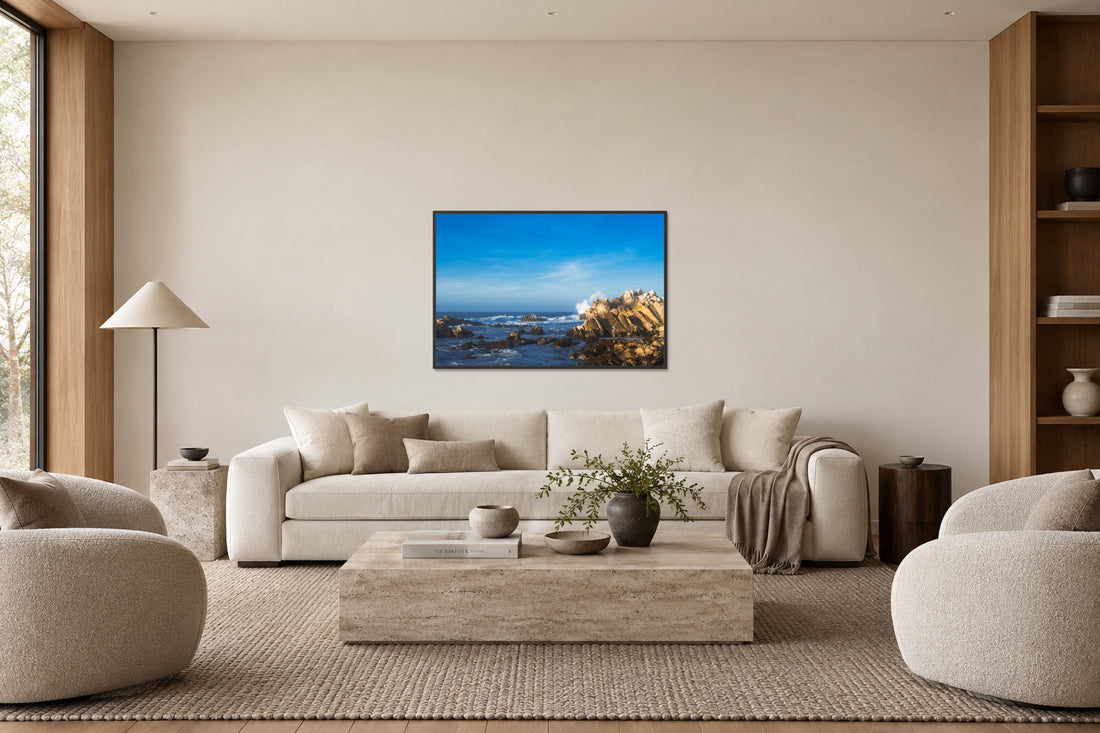 Portal framed coastal artwork above the same sofa